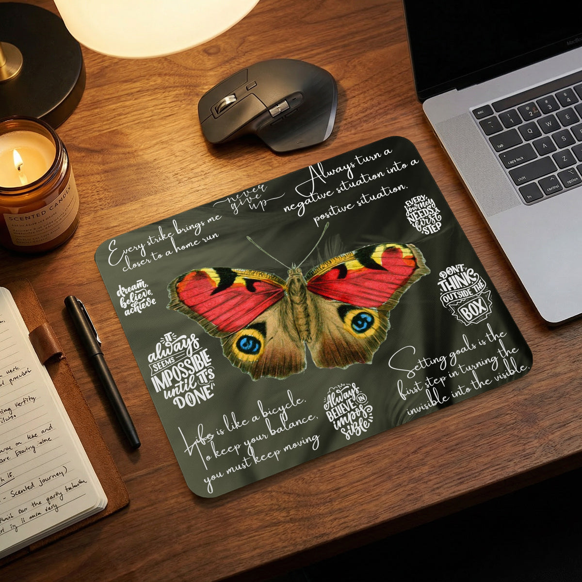 Mousepad with a peacock butterfly design and motivational quotes in white text.