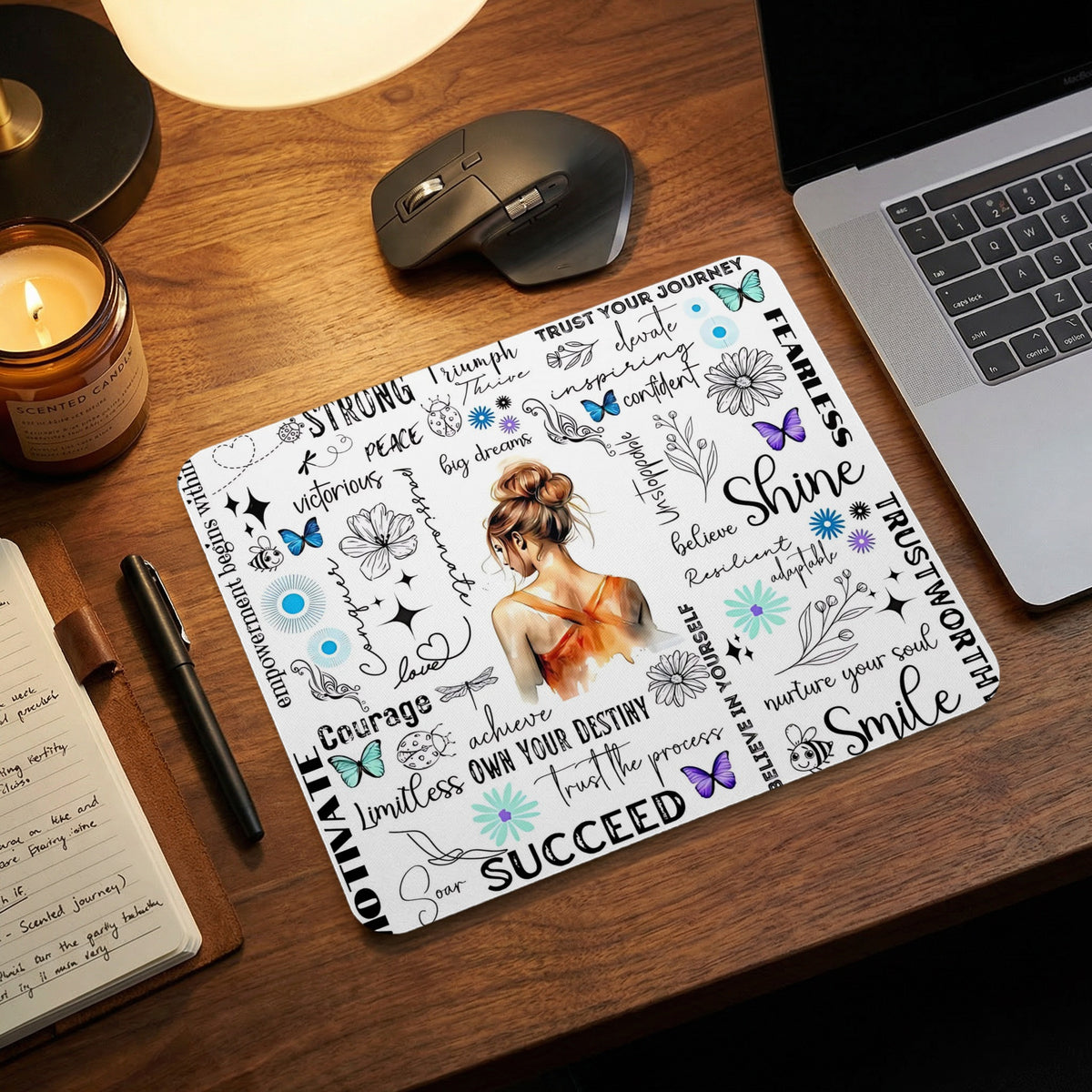 Motivational mousepad with artwork of a woman surrounded by positive words and illustrations.