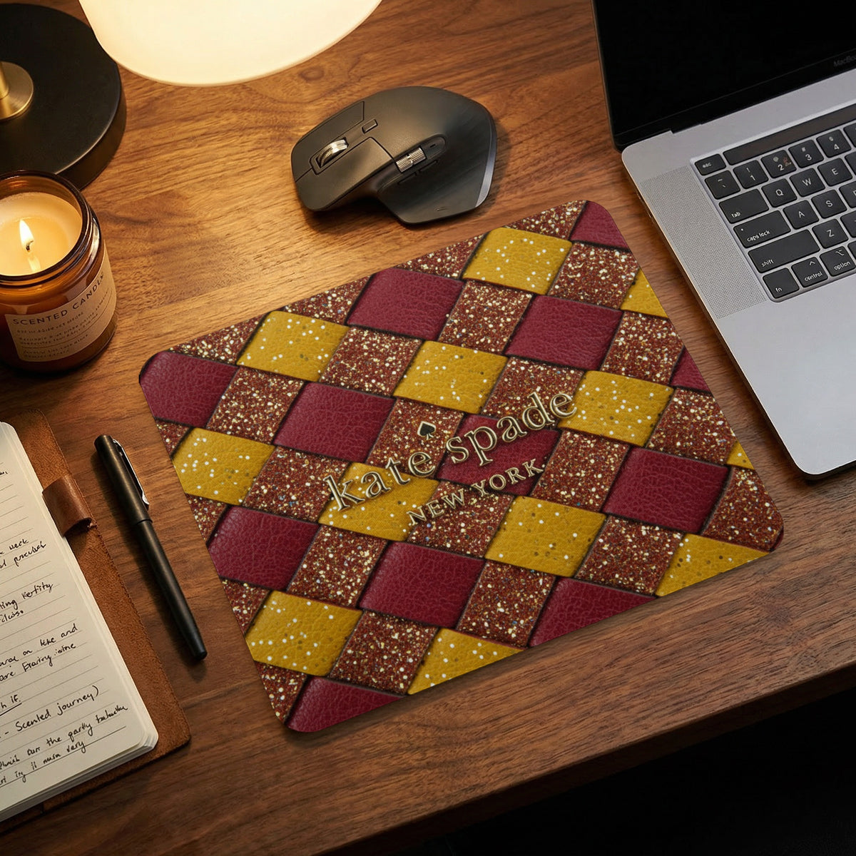 Kate Spade New York mousepad with a woven burgundy, gold, and glitter pattern.