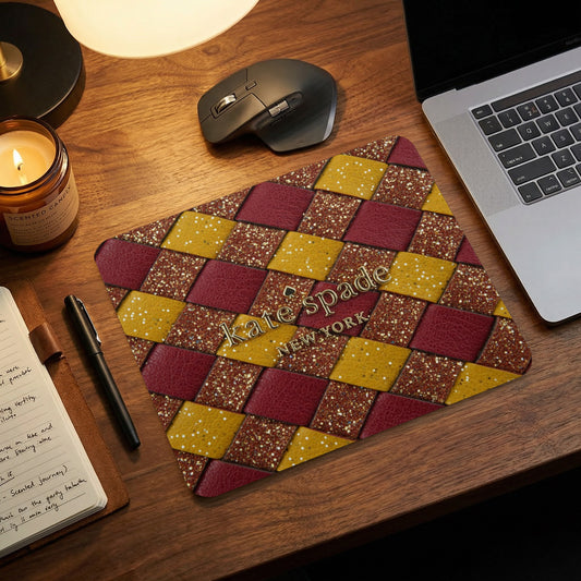 Kate Spade New York mousepad with a woven burgundy, gold, and glitter pattern.