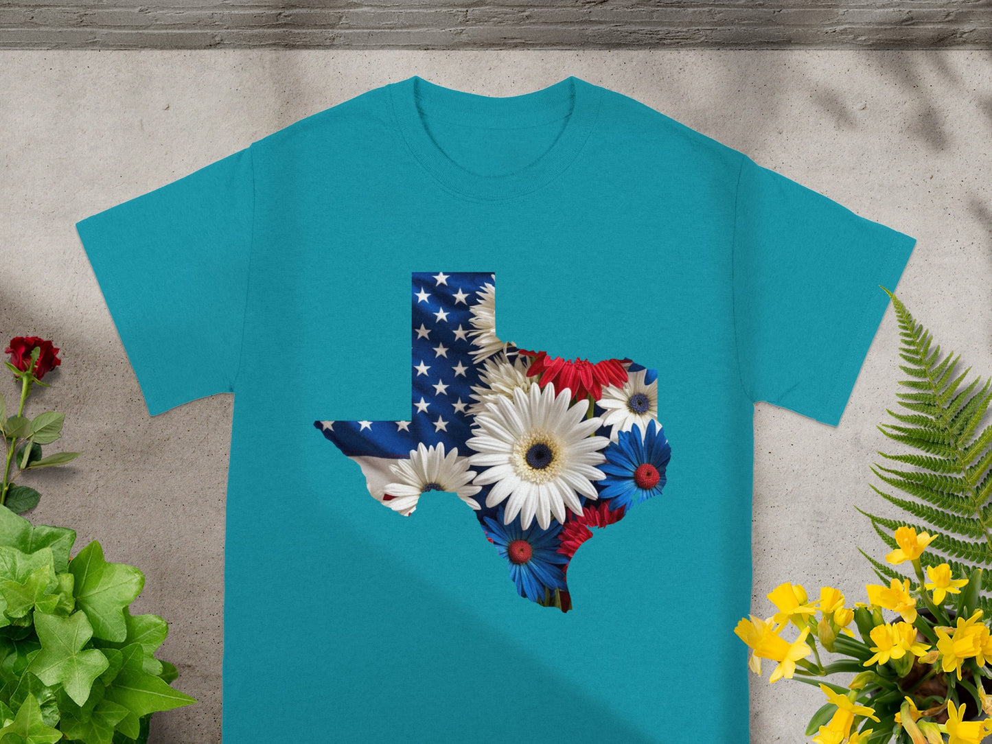 Teal t-shirt with Texas flag and flowers graphic design.