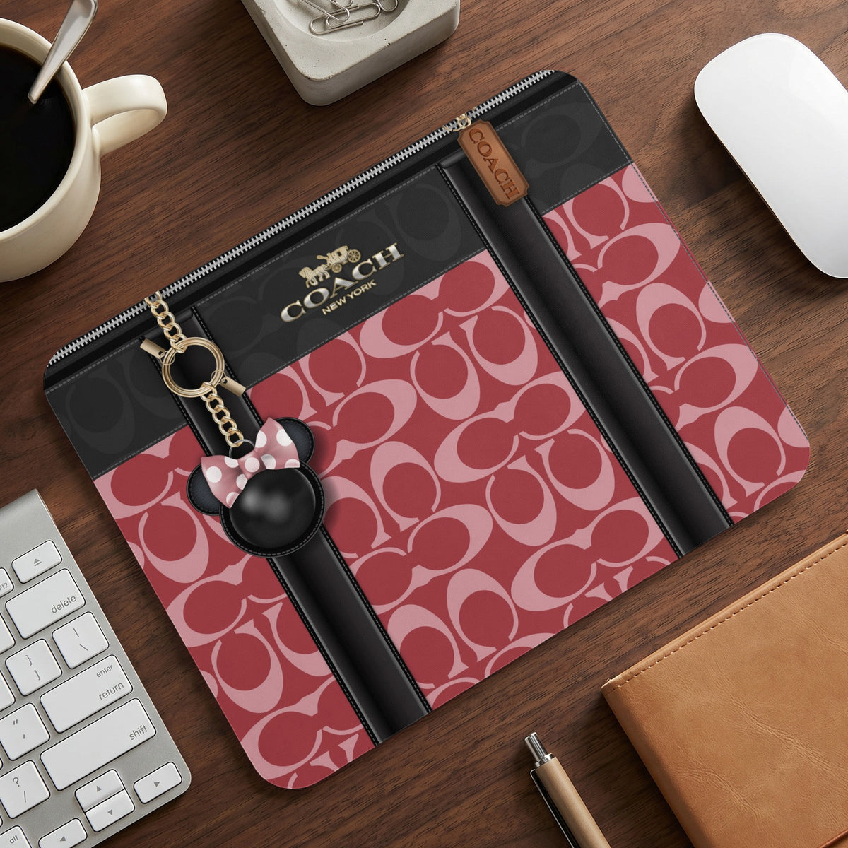 Coach cosmetic case with signature print and Minnie Mouse charm.