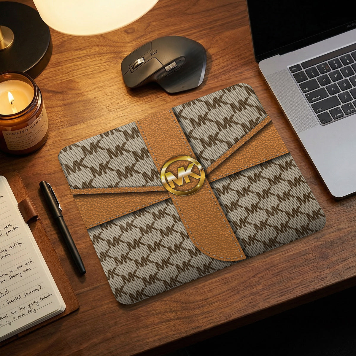 Michael Kors MK logo mousepad with brown leather accents on a wooden desk.