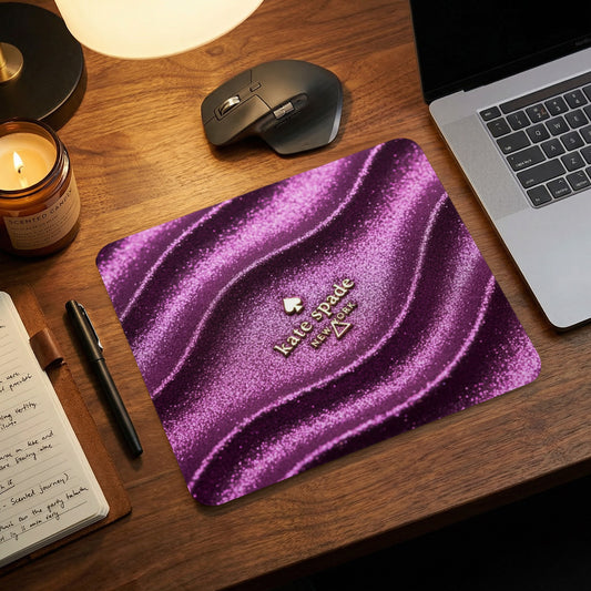 Kate Spade New York mousepad with a shimmering purple wavy design.