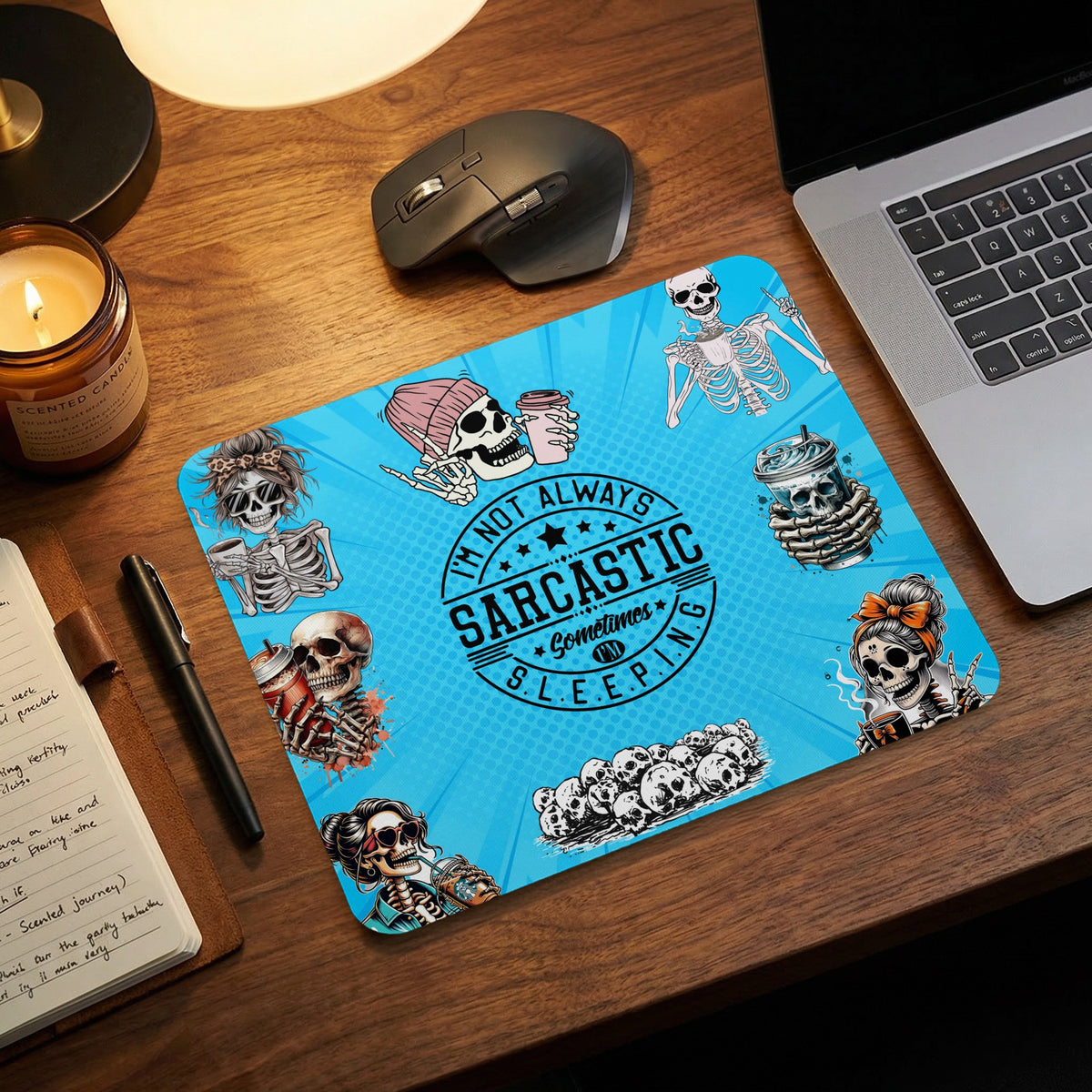 Bright blue mousepad featuring various skeleton illustrations and sarcastic text, placed on a wooden desk.