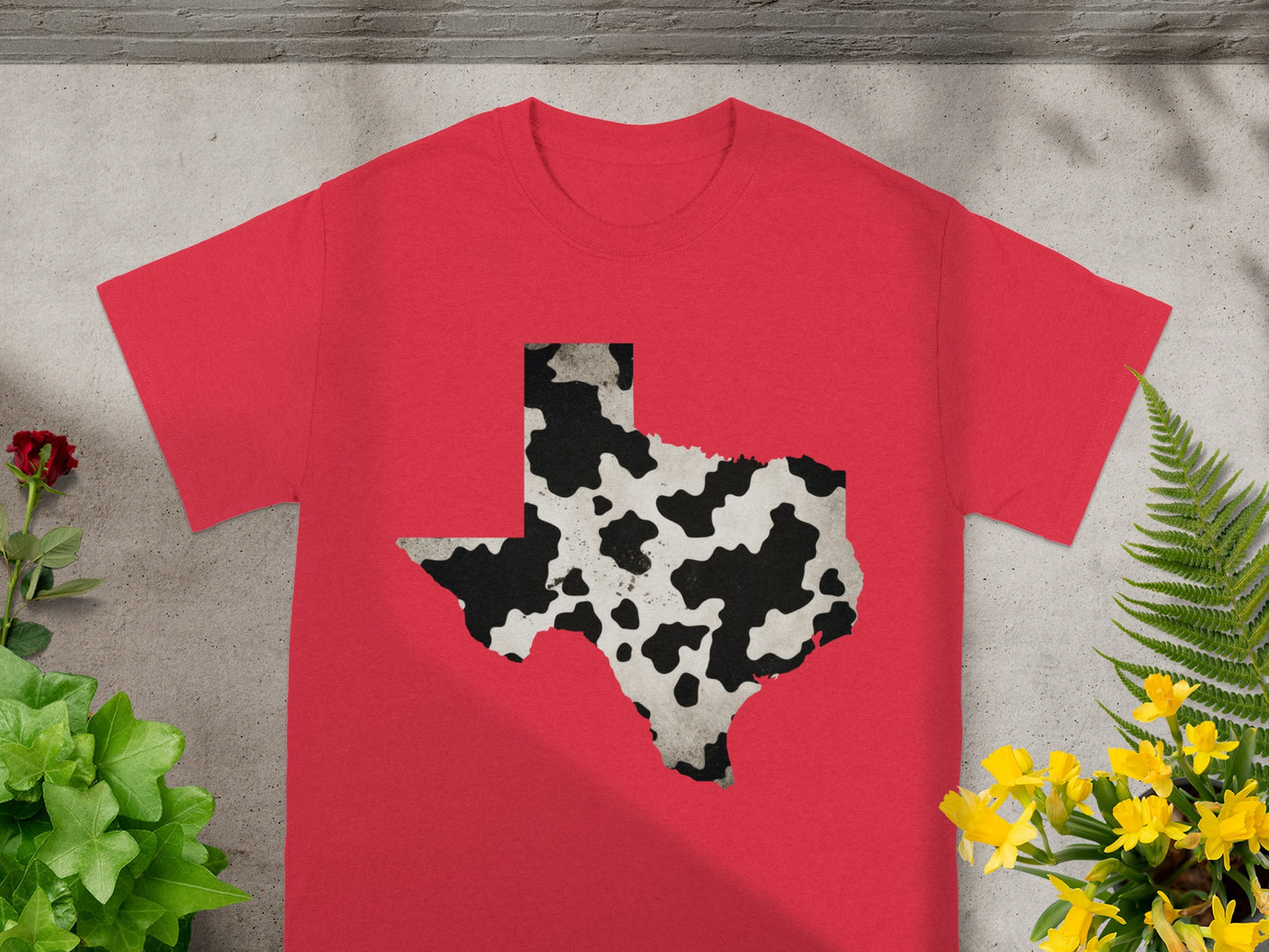 Red t-shirt with Texas silhouette in cow print pattern.