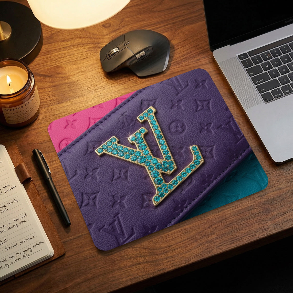 Purple mousepad with embossed pattern and jeweled logo on desk.