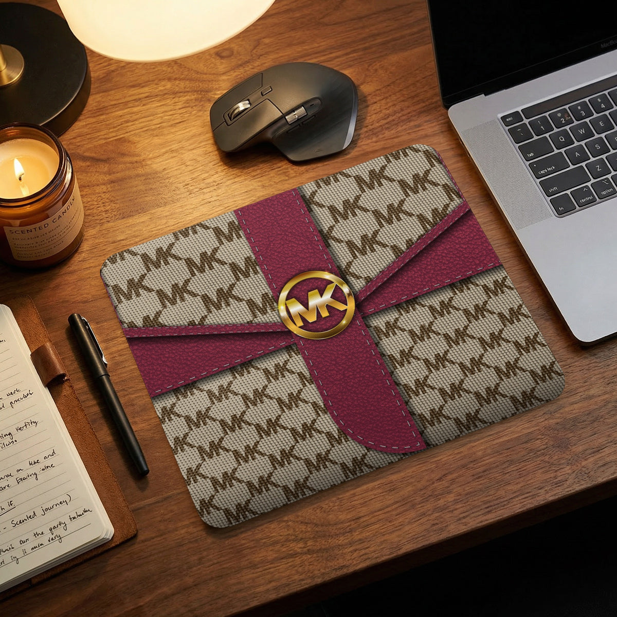 Michael Kors patterned mousepad with gold logo and red ribbon detail.