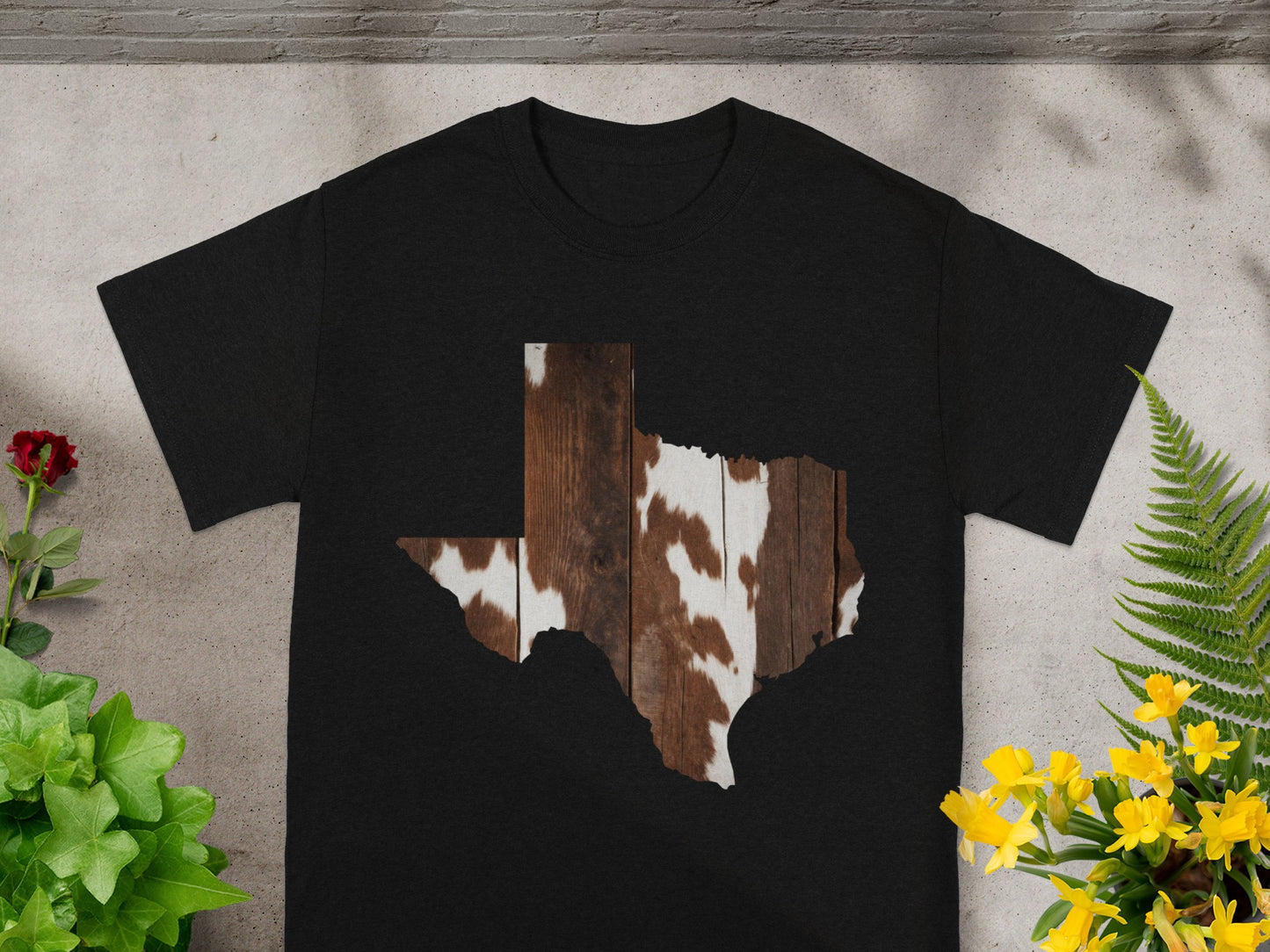 Black t-shirt with Texas shape filled with wood and cowhide print.