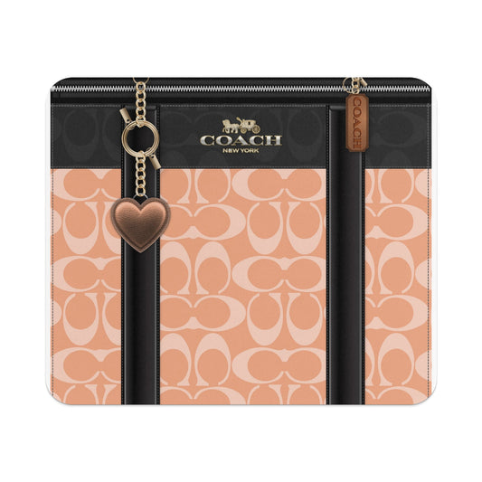 Coach canvas wallet with C logo pattern, heart charm, and zipper closure.