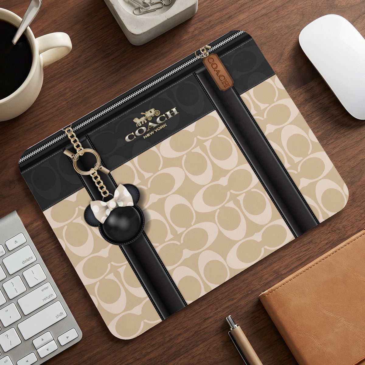 Coach mouse pad with signature C pattern and Mickey Mouse charm.