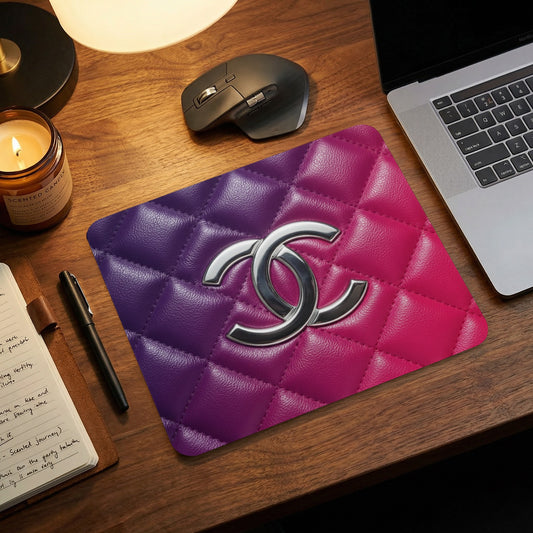Chanel logo on quilted purple and pink gradient mousepad with laptop.