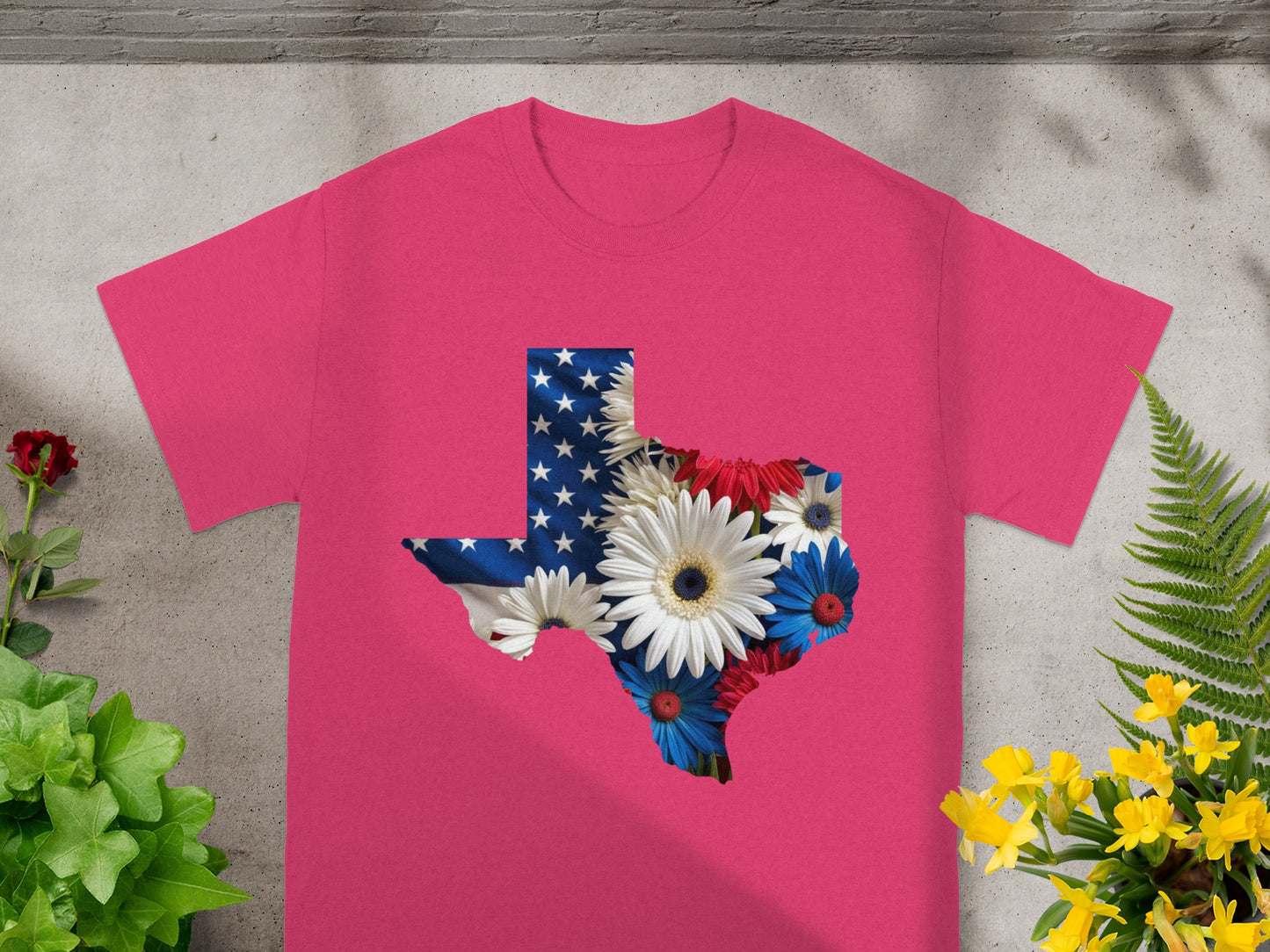 Pink t-shirt with a Texas map graphic filled with American flag and flowers.