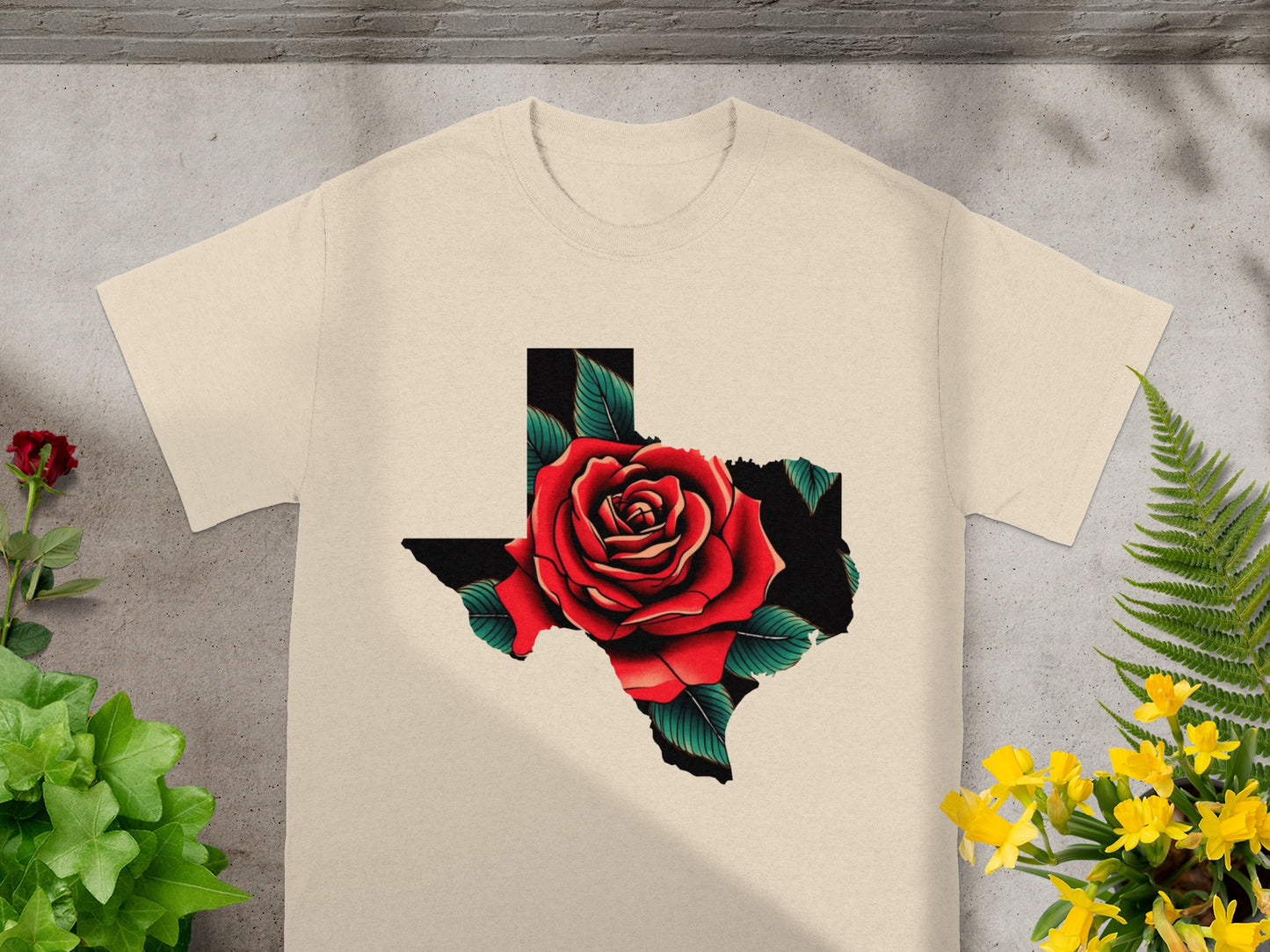 Cream t-shirt with Texas shape filled by a red rose and green leaves.