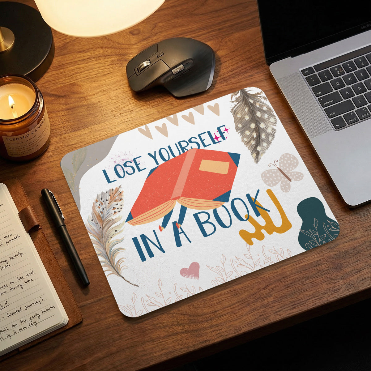 Mousepad with "Lose Yourself in a Book" text, open book graphic, feathers, and butterflies.