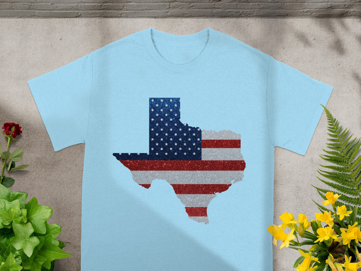 Light blue t-shirt with Texas shape filled with an American flag graphic.