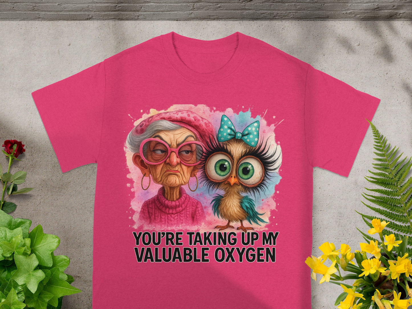 Pink t-shirt with a grumpy older woman and a cartoon owl wearing a bow tie.