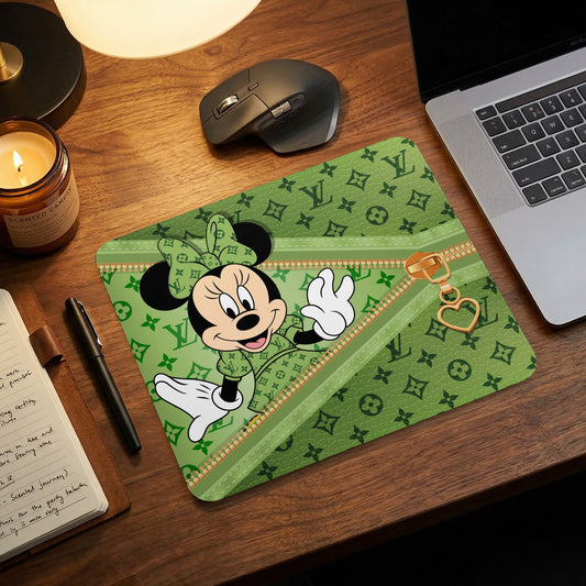Minnie Mouse on a green mousepad with LV-inspired pattern and heart zipper pull.