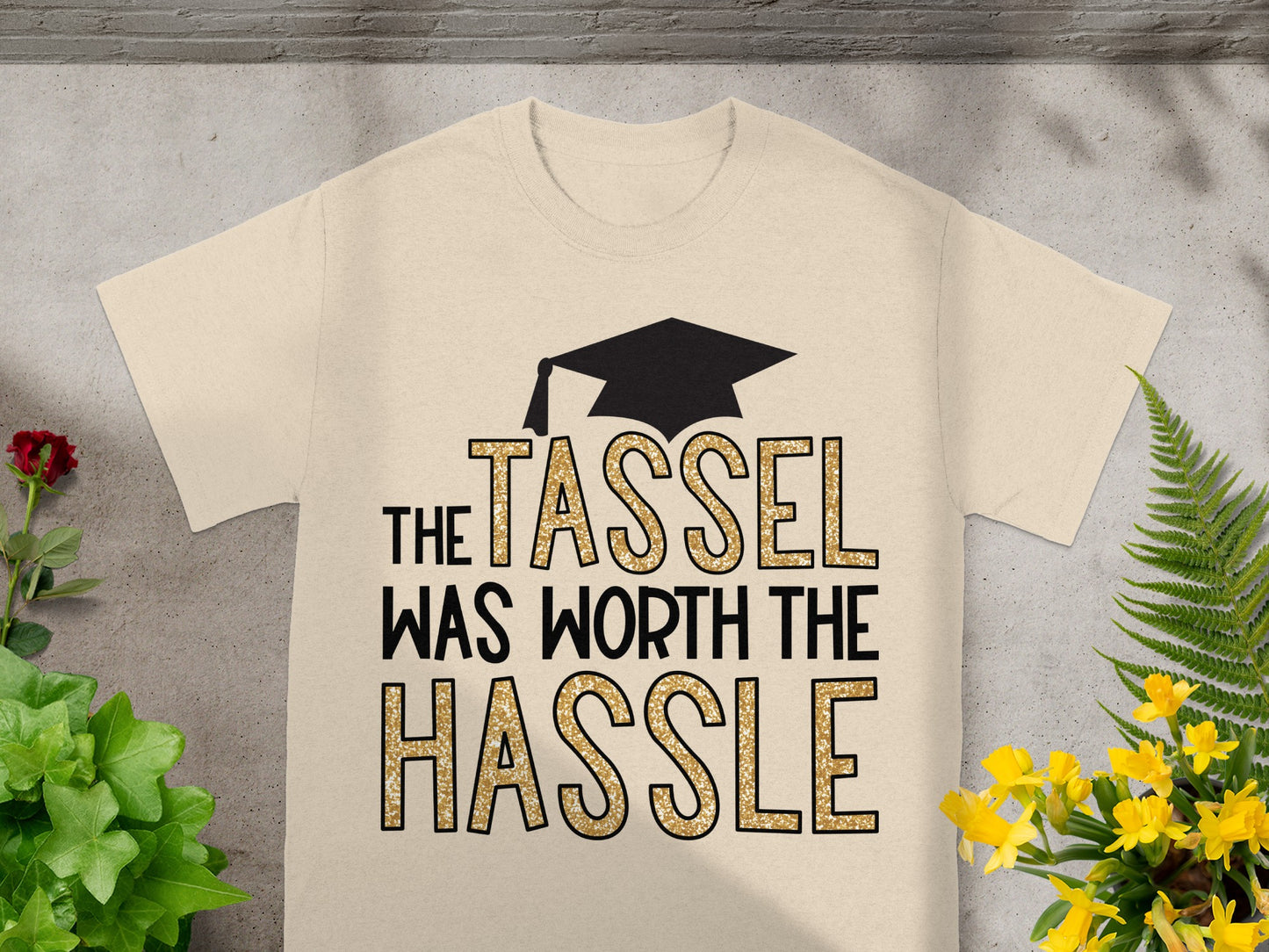 Cream t-shirt with graduation cap and "The Tassel Was Worth The Hassle" text.
