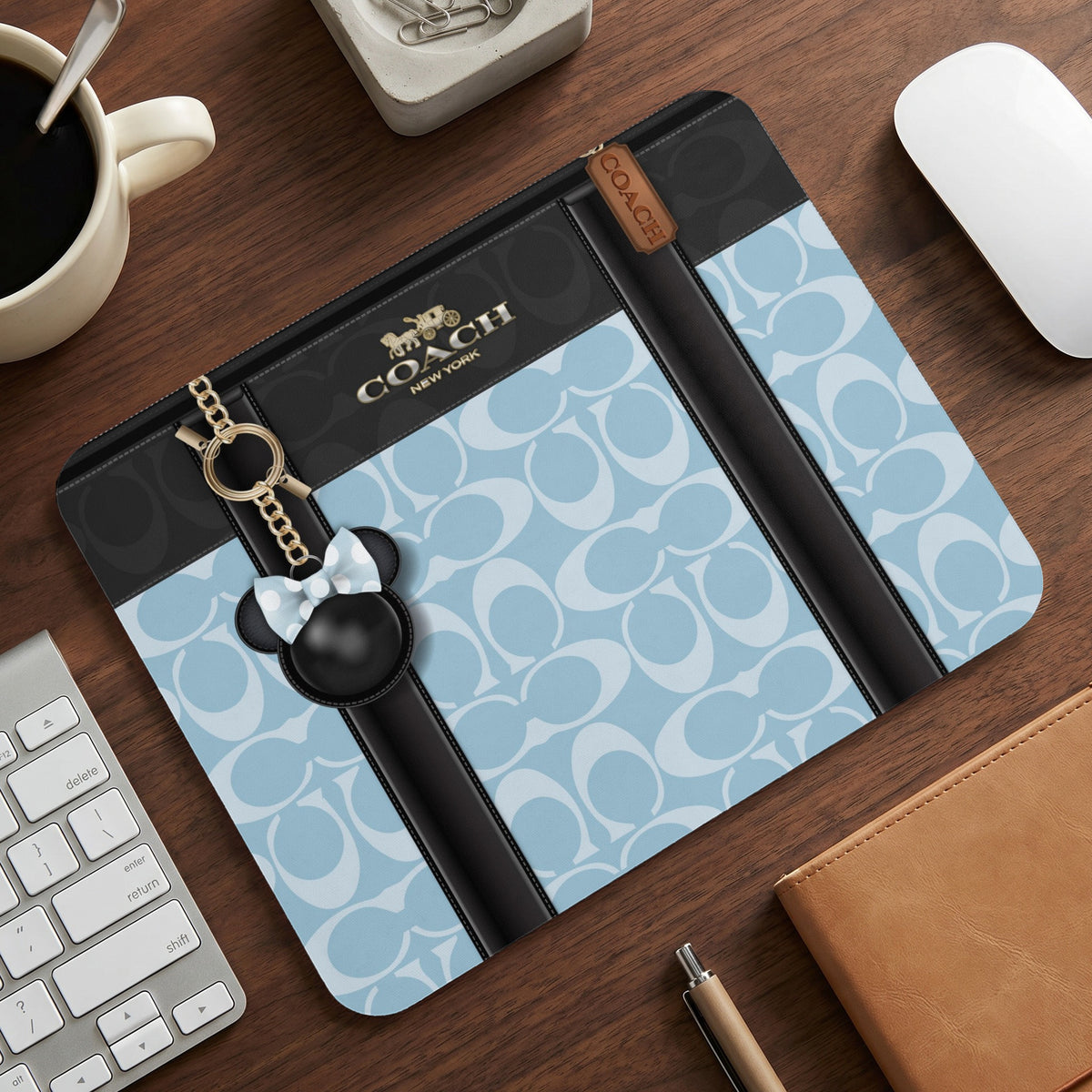 Coach mousepad with light blue all-over logo print and Mickey Mouse charm.