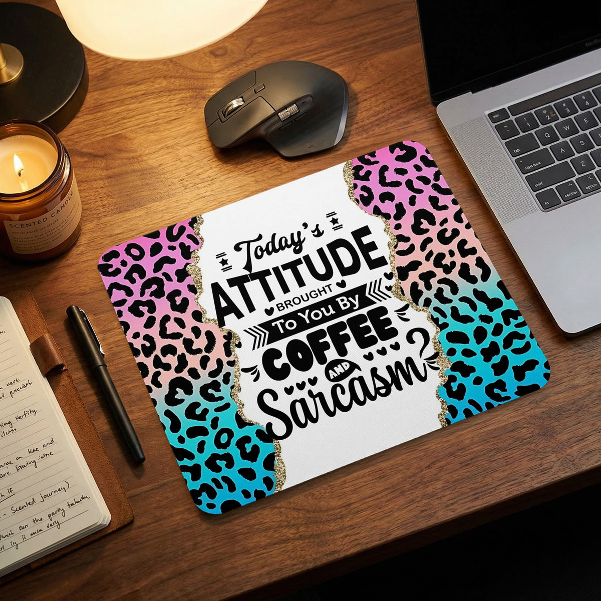 A mouse pad featuring pink and blue leopard print and the text Today Attitude Brought To You By COFFEE AND Sarcasm.