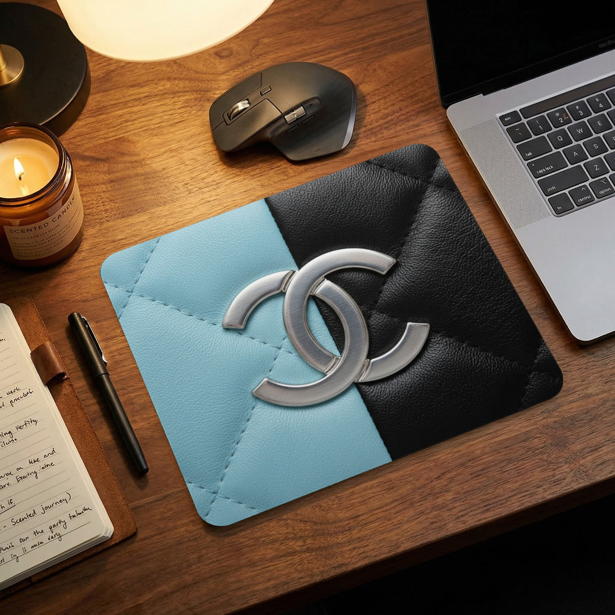 Quilted light blue and black mousepad with interlocking silver "CC" logo.