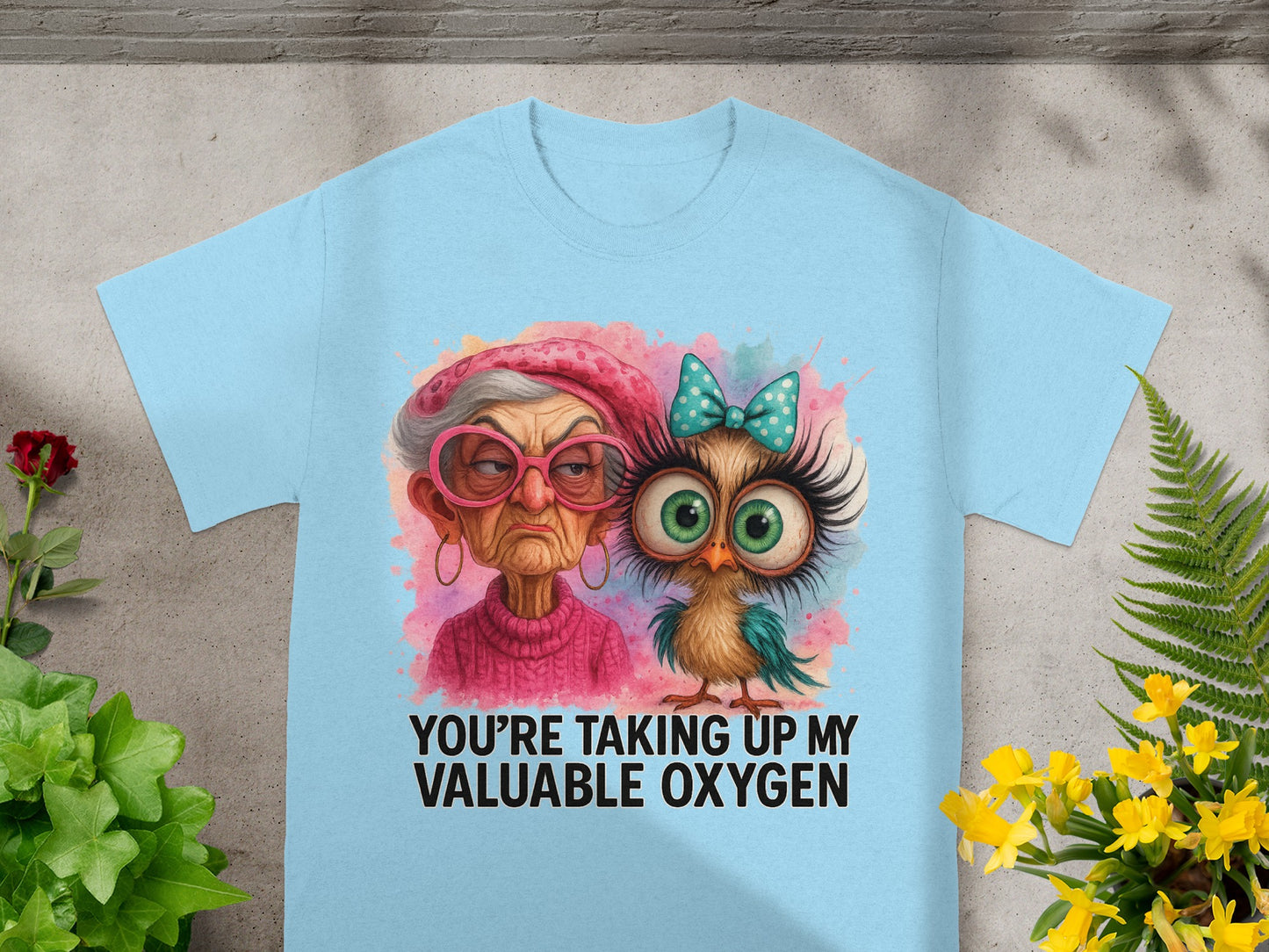 Light blue t-shirt with a grumpy older woman and a small owl graphic.