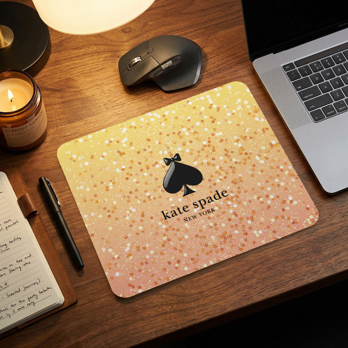 Kate Spade New York mousepad with glitter gradient and spade logo.