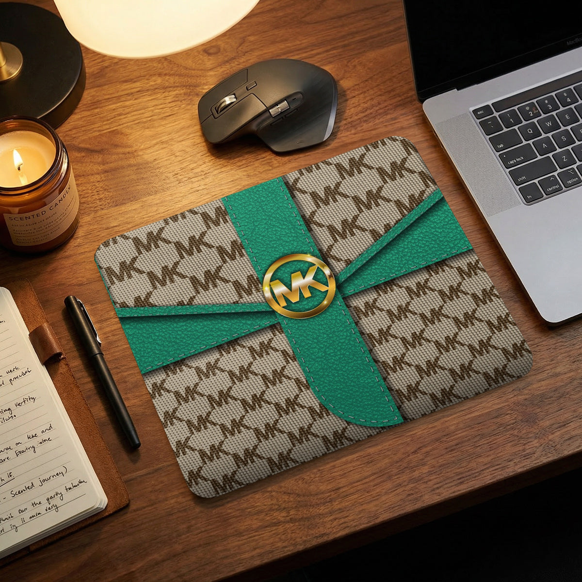 Michael Kors patterned mousepad with teal ribbon detail and gold logo.