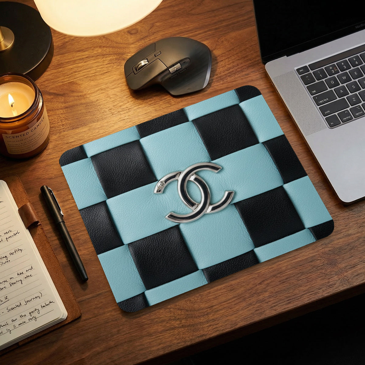 Blue and black woven mousepad with silver Chanel logo.