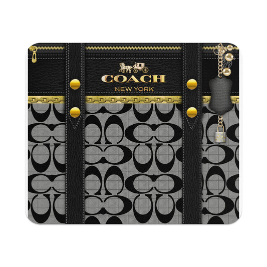 Coach logo with horse and carriage, black leather, gold chain, and monogram pattern.