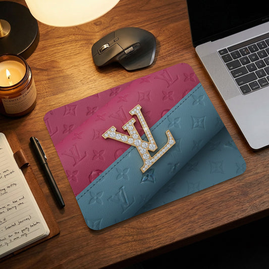 Mousepad with diamond encrusted LV logo on pink and teal textured surface.