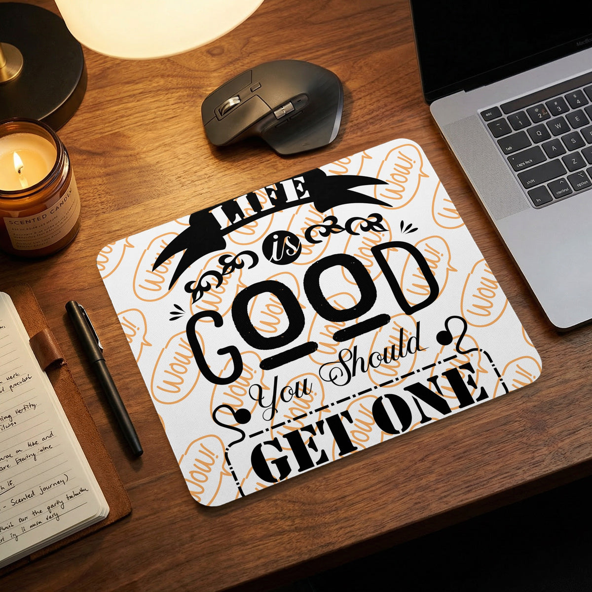 White mousepad with the text Life is Good You Should Get One on a wooden desk.