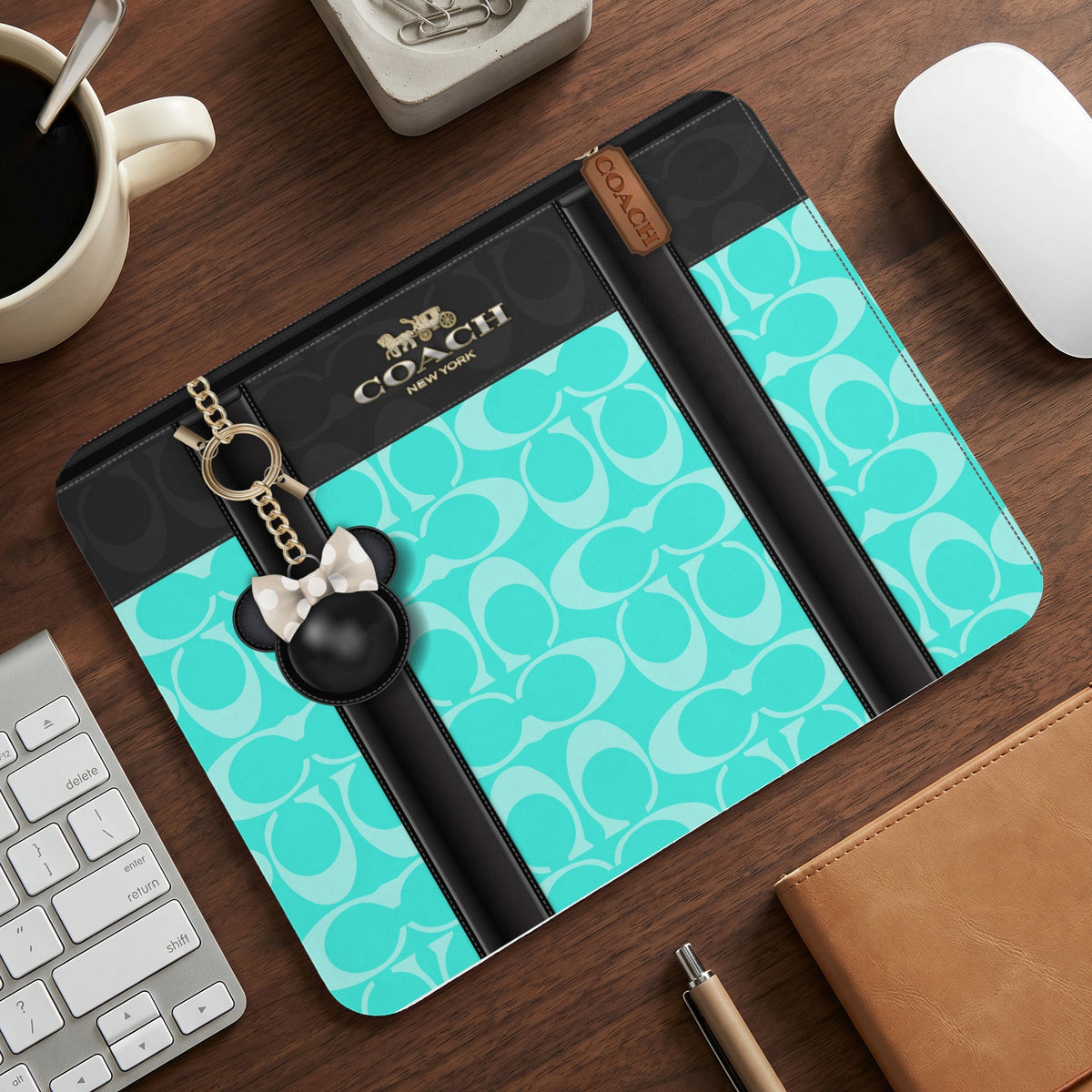 Coach mousepad with signature logo pattern and Mickey Mouse charm.