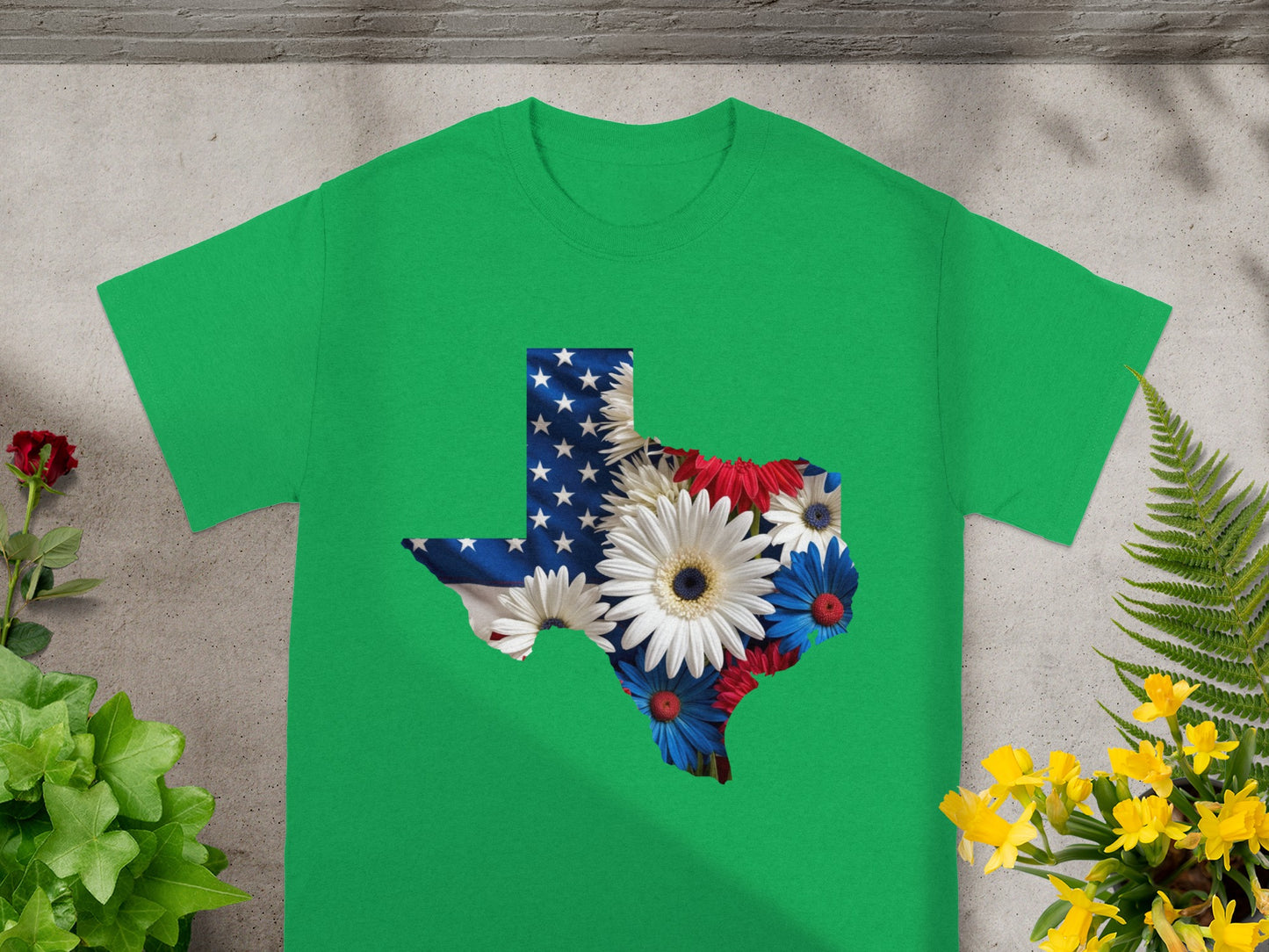 Green t-shirt with Texas flag overlaid with patriotic flowers.