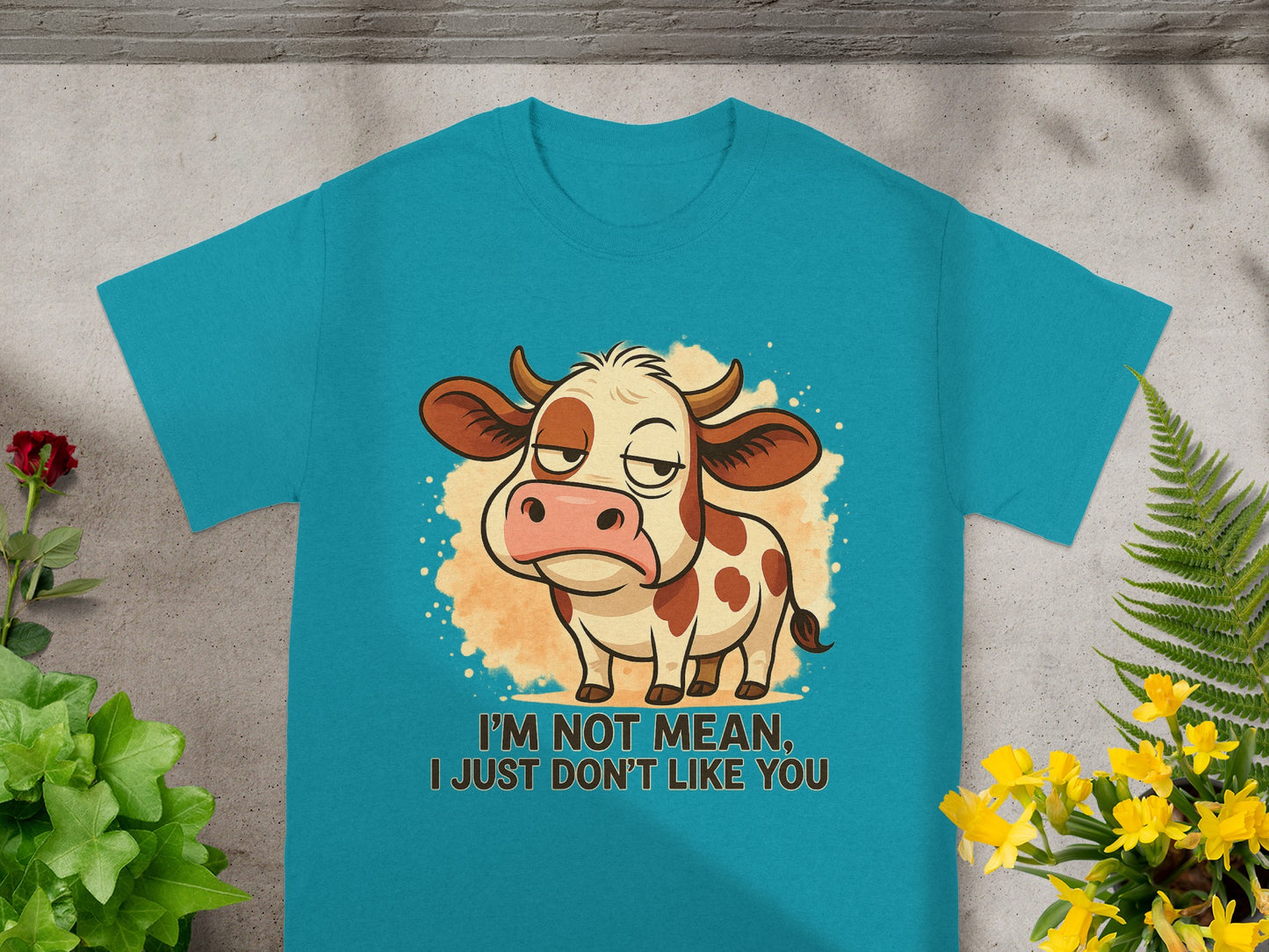 Teal t-shirt with a cartoon cow and text "I'm not mean, I just don't like you."