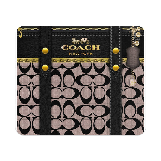 Coach signature pattern wallet with black leather trim, gold chain, and key charm.