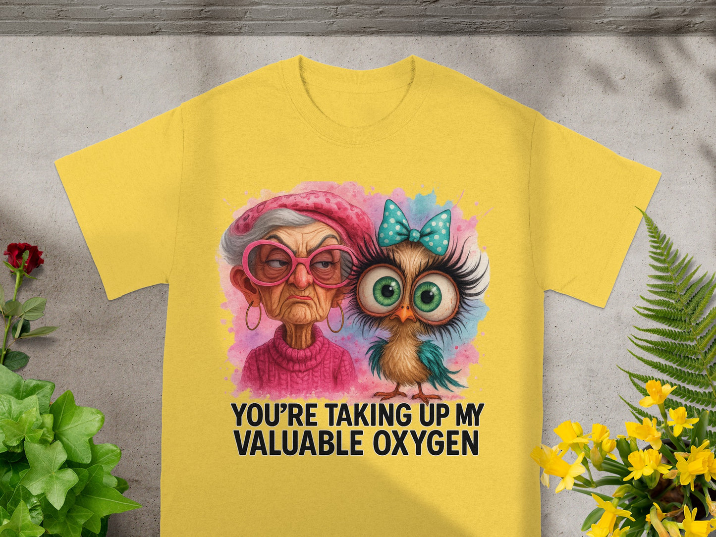 Yellow t-shirt with a grumpy woman and a bird, text says "YOU'RE TAKING UP MY VALUABLE OXYGEN".