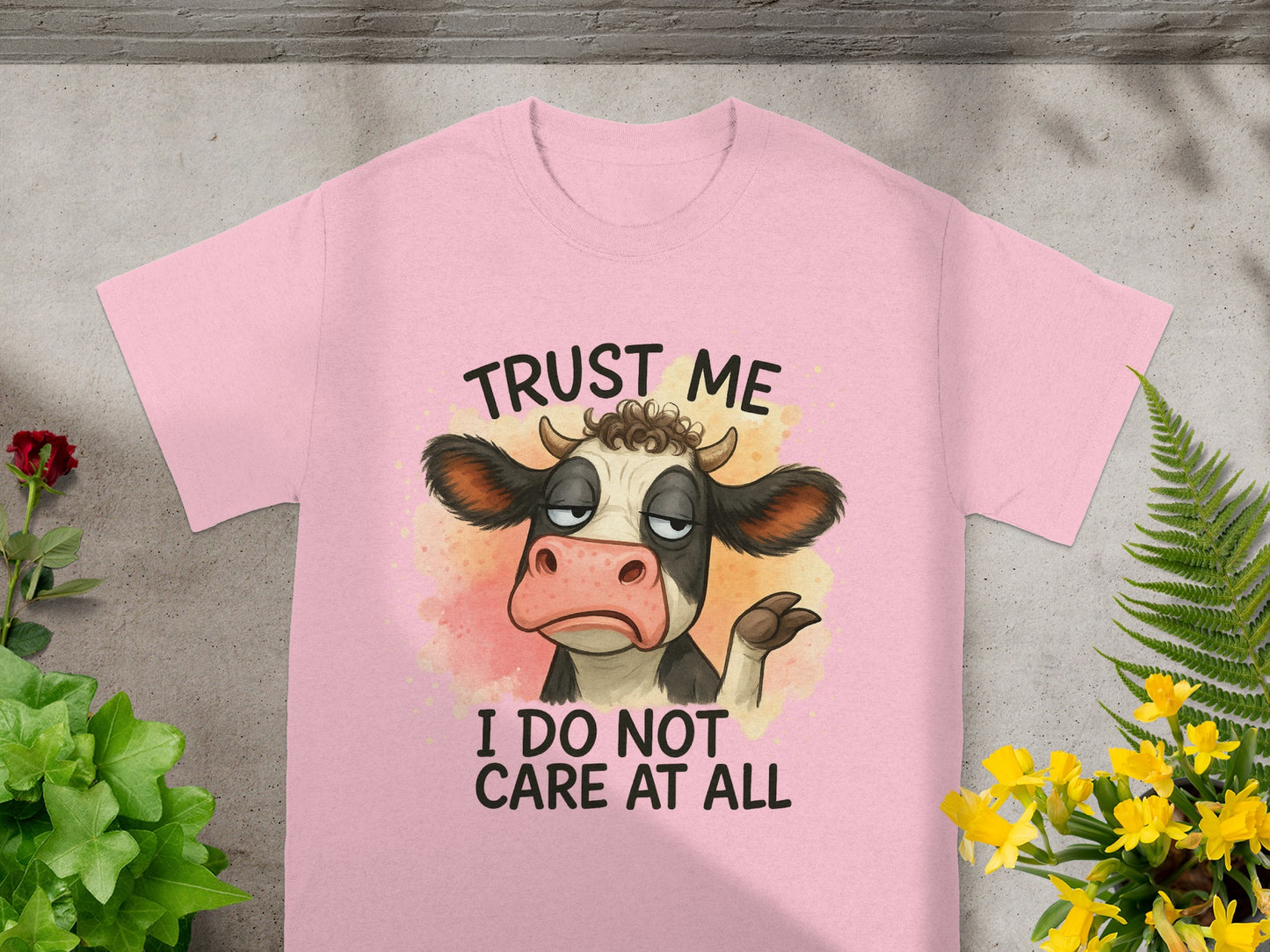 Pink t-shirt with a cow graphic saying "Trust me I do not care at all."