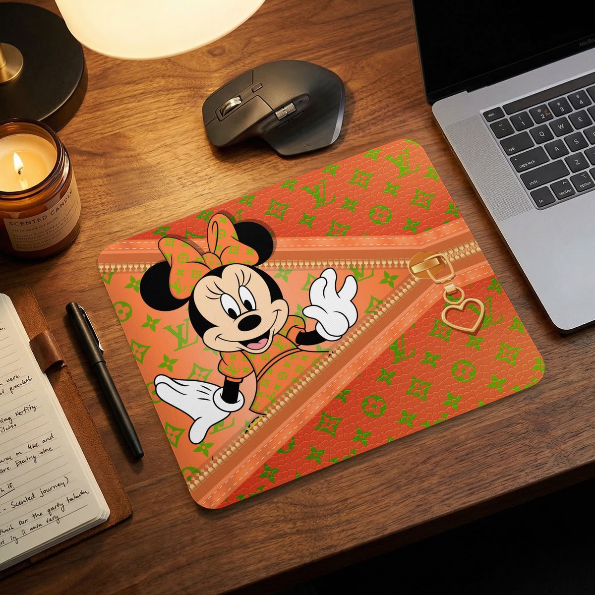 Minnie Mouse on orange mousepad with green monogram pattern and gold zipper detail.