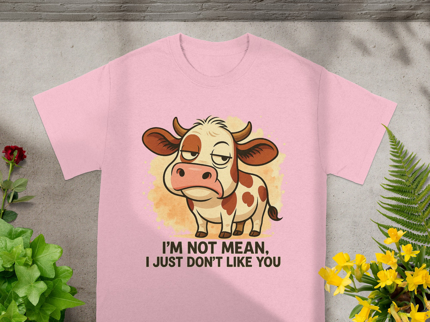 Pink t-shirt with cartoon cow and text "I'm not mean, I just don't like you."