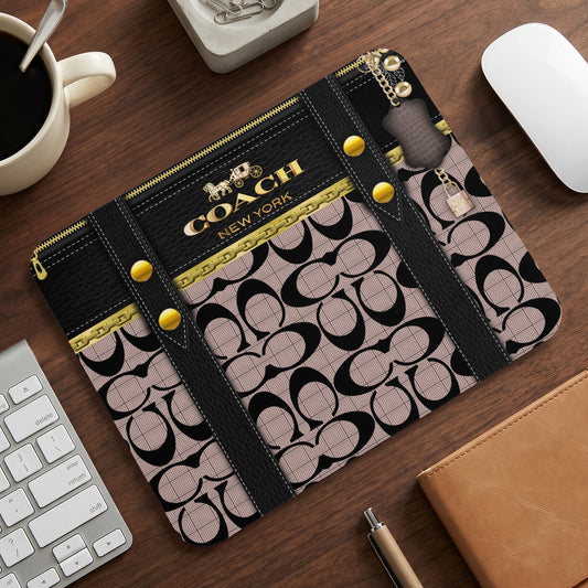 Coach New York logo and repeating "C" pattern mousepad with leather straps.