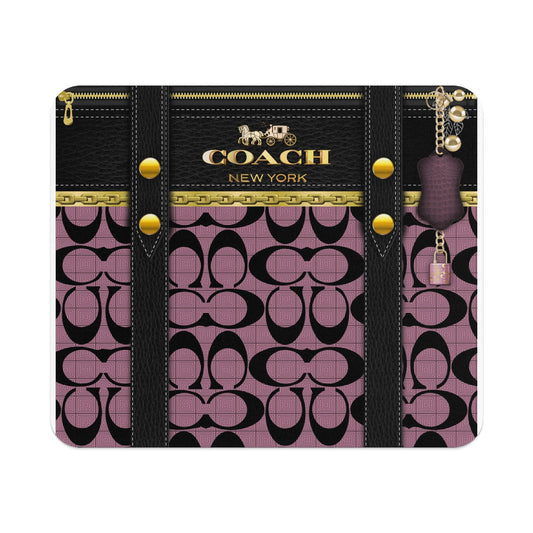 Coach pattern with leather straps, gold zipper, chain, charm, and lock.