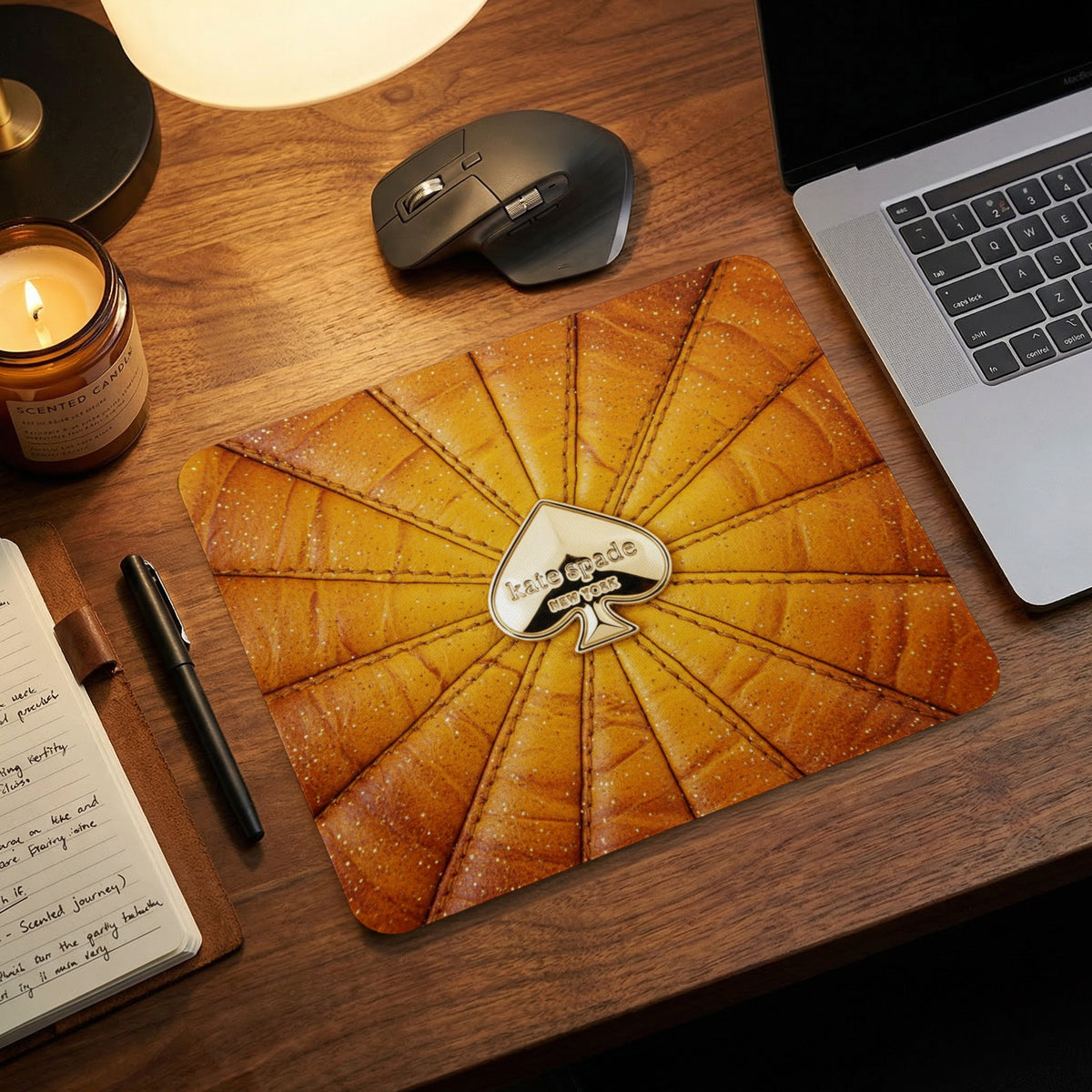 Kate Spade mousepad with metallic spade logo and textured yellow design.