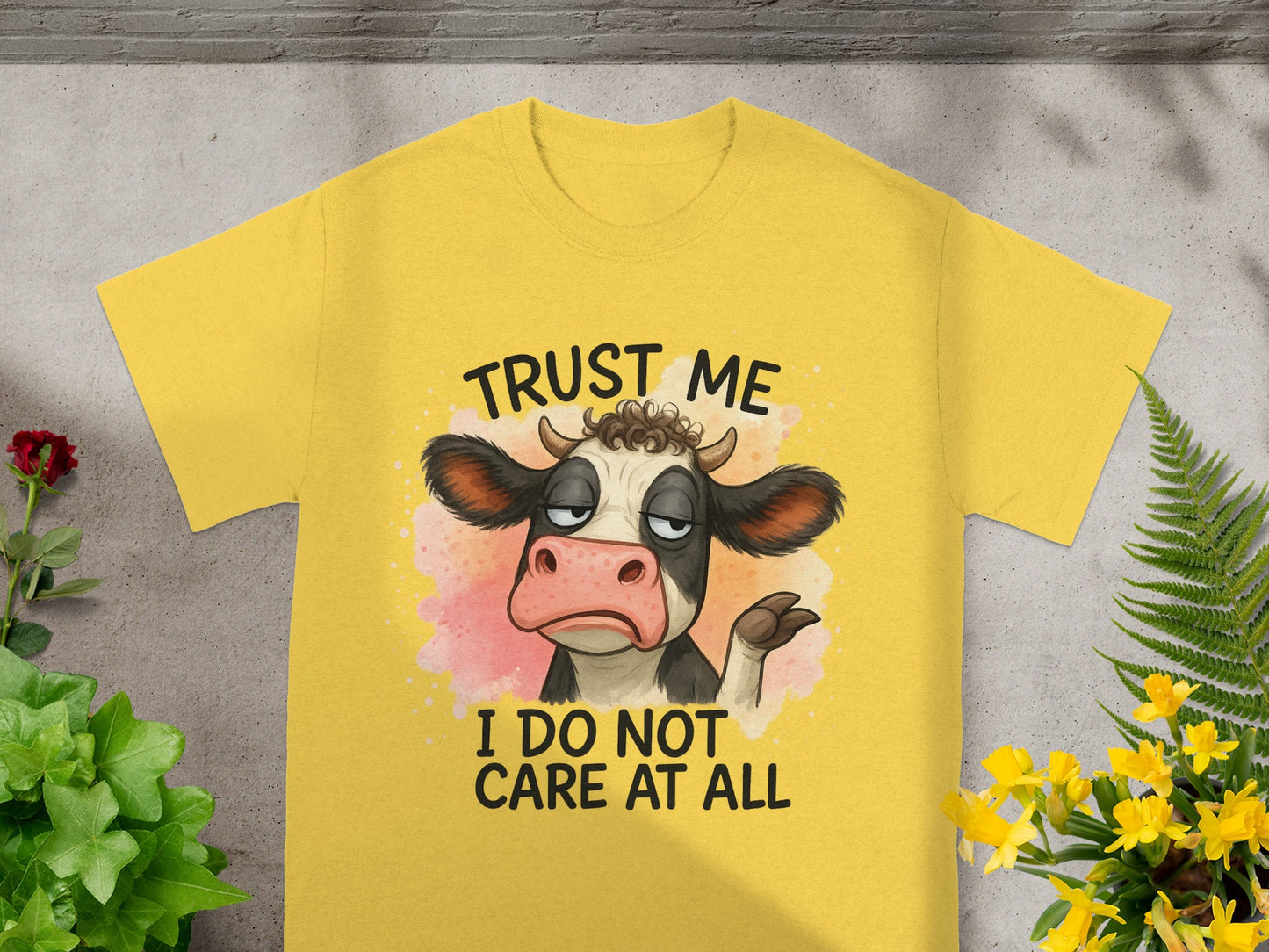 Yellow t-shirt with a cartoon cow saying "Trust me I do not care at all".