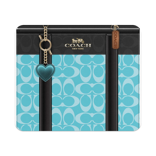 Coach New York teal monogram pattern wallet with gold chain and heart charm.