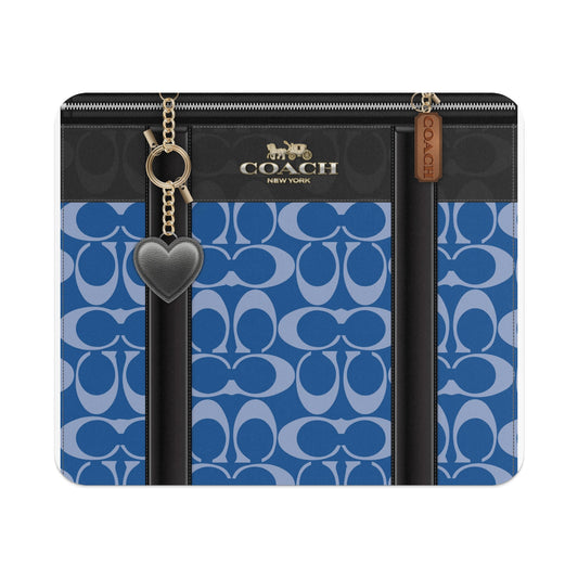 Coach blue monogram wallet with heart charm and gold hardware.
