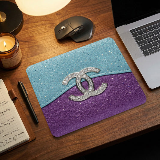 Mousepad with interlocking double C logo over blue and purple glitter sections.