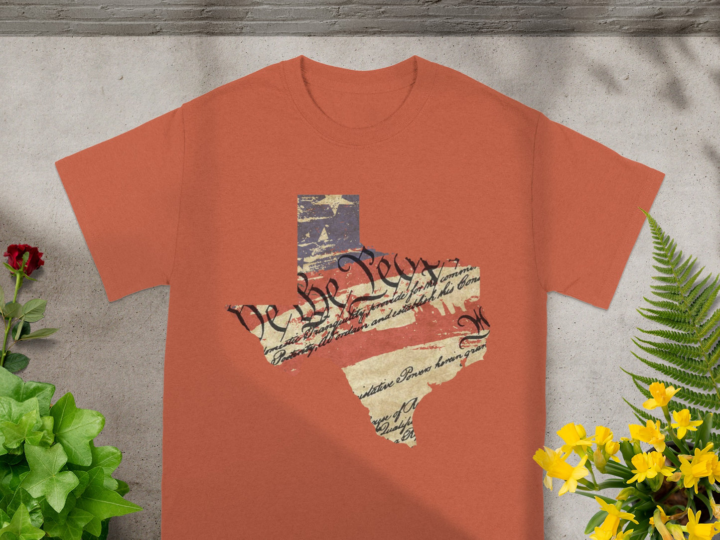 Orange t-shirt with Texas shape featuring US flag and constitution text.