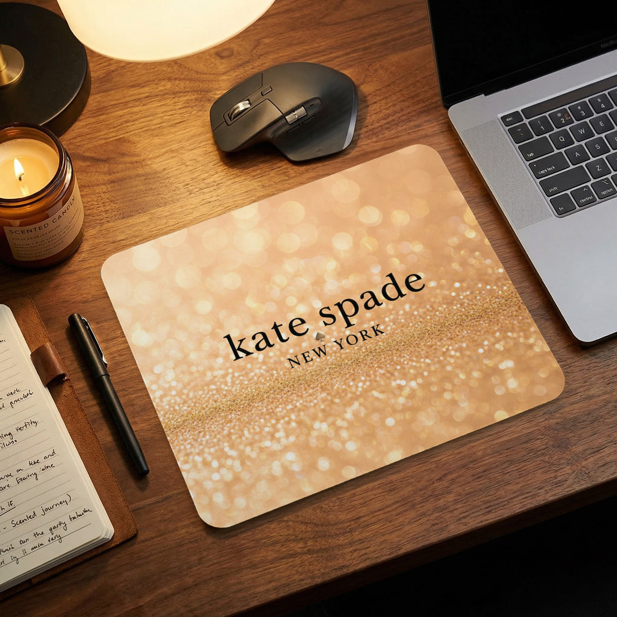 Kate Spade New York logo on a gold glitter mousepad.